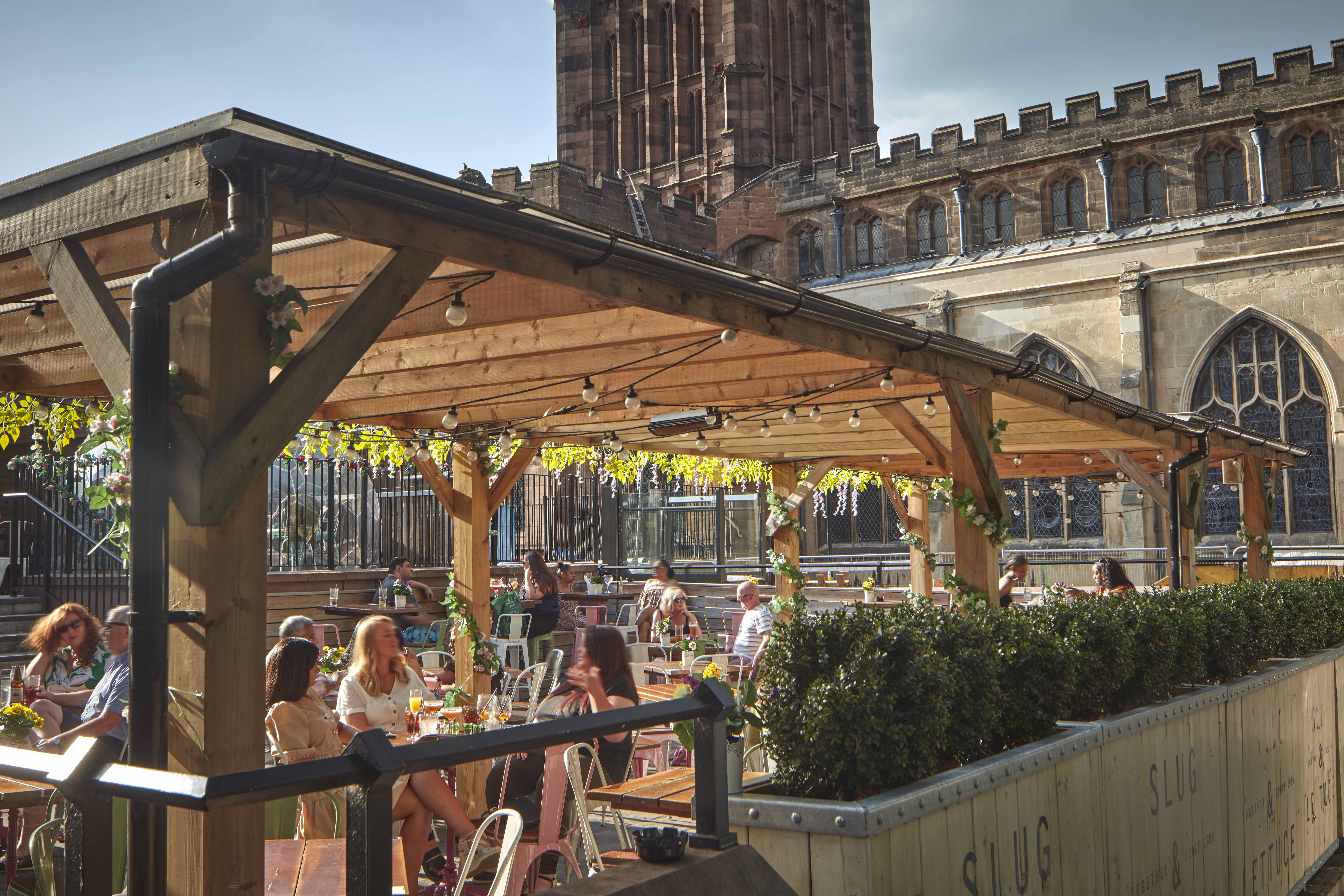 People sitting at a bar in Coventry in the sun