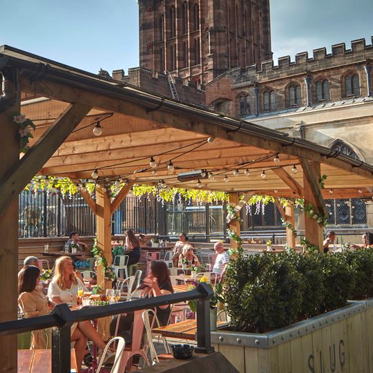 People sitting at a bar in Coventry in the sun